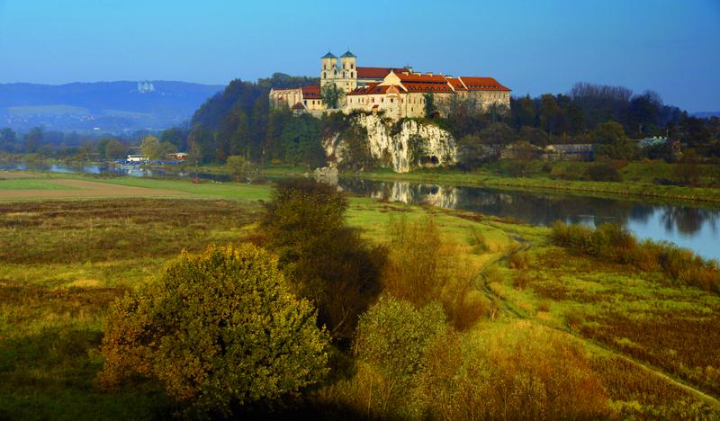 Biały klasztor na wzgórzu nad rzeką.